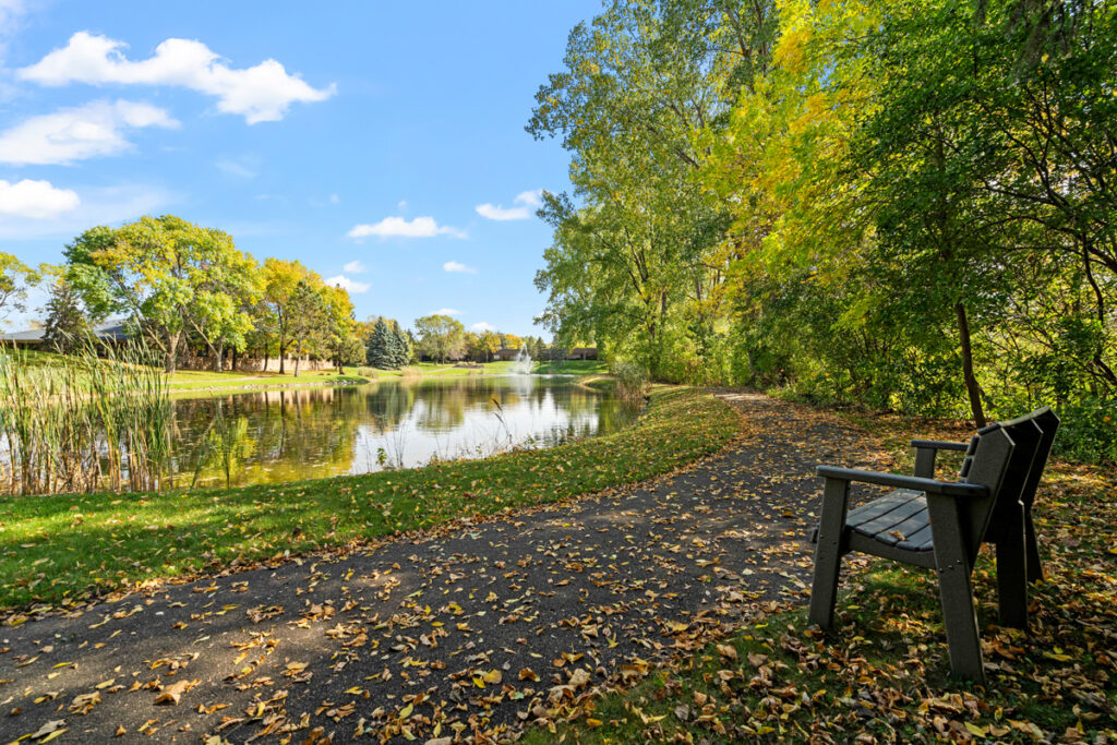 Peaceful walking path and pond near Emerald Crest Burnsville offering residents access to nature and outdoor enjoyment.