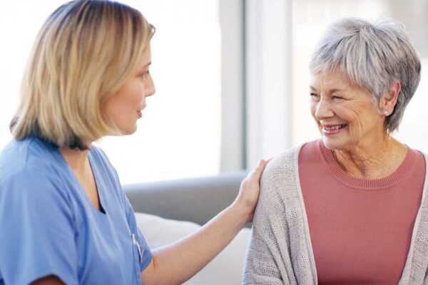 A resident and caregiver interact in a supportive setting that reflects Emerald Crest's expertise in providing personalized Alzheimer's and dementia care.