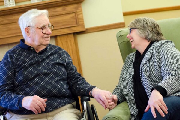 A resident and family member spend time together at Emerald Crest, reflecting the reassurance, support, and dependable memory care families can trust.