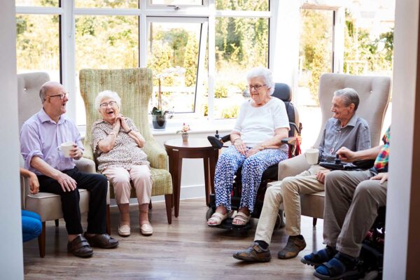 Residents gather in a bright community space at Emerald Crest, enjoying social interaction, meaningful activities, and personalized memory care support.