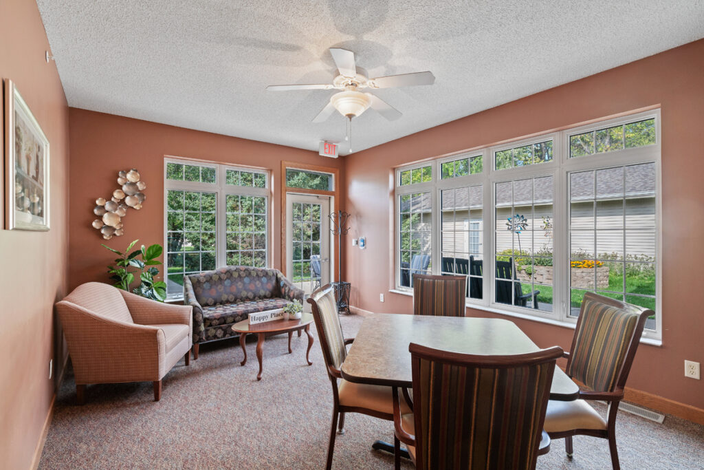Bright sunroom at Emerald Crest Shakopee offering residents a comfortable space for activities, conversation, and relaxation.
